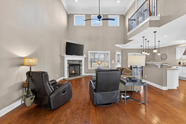 a living room with furniture a flat screen tv and a fireplace