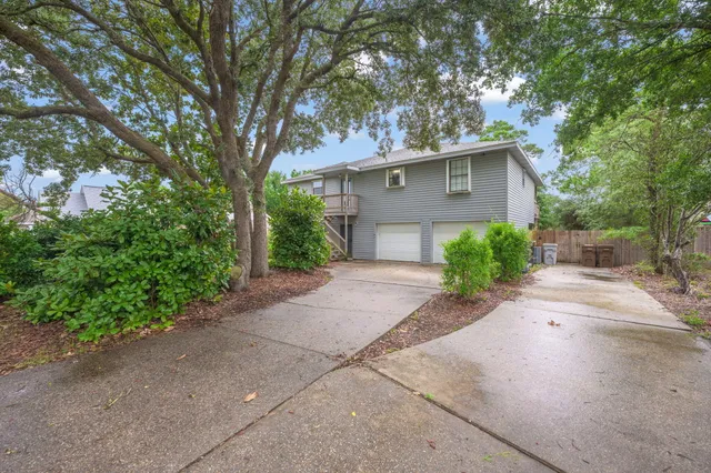 a front view of a house with a yard and a garage