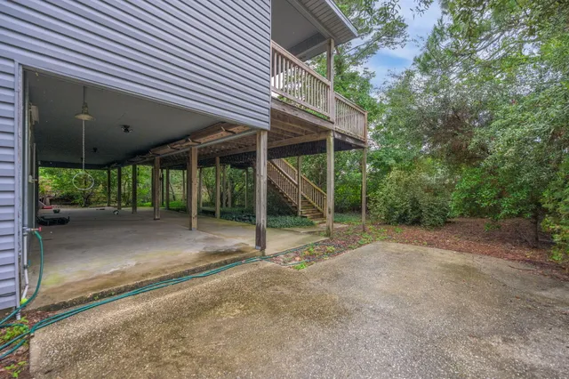 a view of an empty room with wooden floor and windows