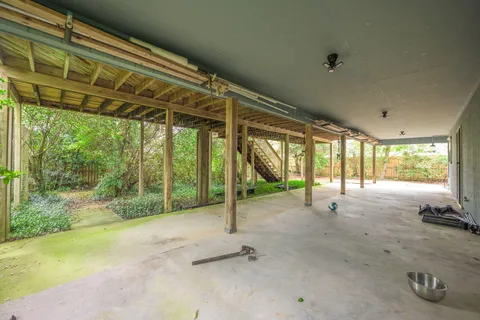 a backyard of a house with a garden and outdoor seating