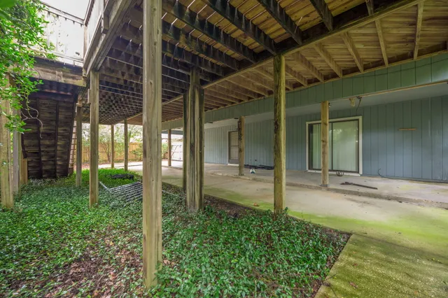 a kitchen with stainless steel appliances granite countertop a refrigerator a stove a sink a dining table and chairs with wooden floor