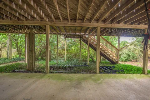 a kitchen with stainless steel appliances kitchen island wooden floors and white cabinets