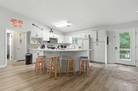 a kitchen with stainless steel appliances granite countertop a refrigerator sink and cabinets