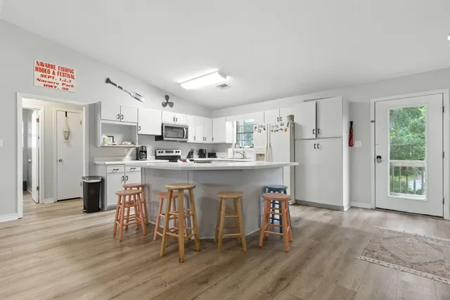 a kitchen with stainless steel appliances granite countertop a refrigerator sink and cabinets