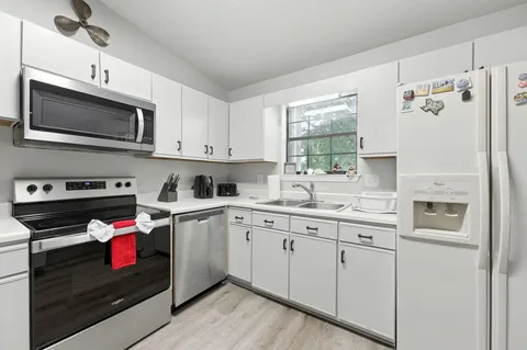 a living room with furniture a rug and a chandelier