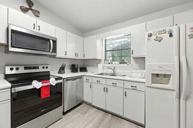 a living room with furniture a rug and a chandelier