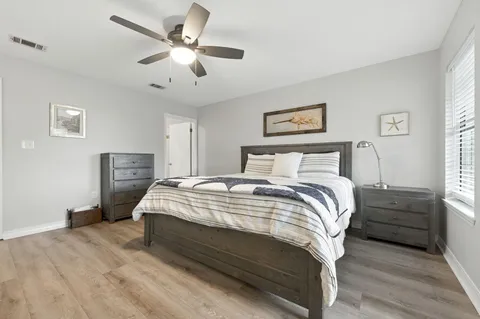 a bathroom with a granite countertop toilet a sink and a window