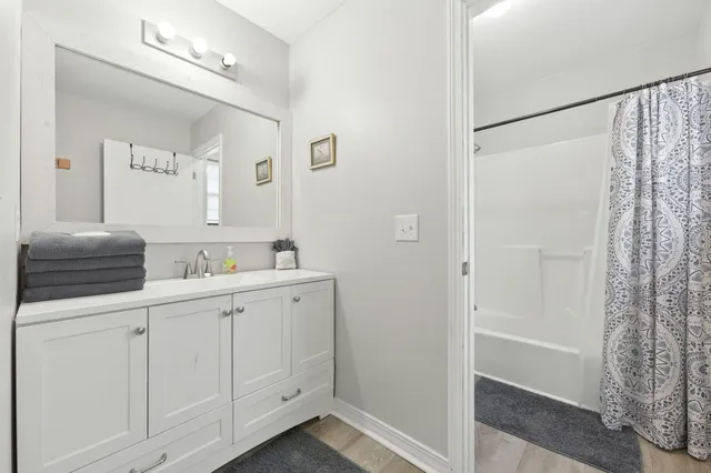 a room with a bed and a large mirror with a chandelier