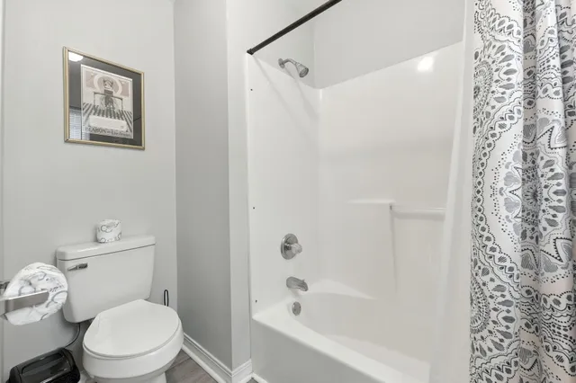 a bedroom with a bed and a flat tv screen on dresser