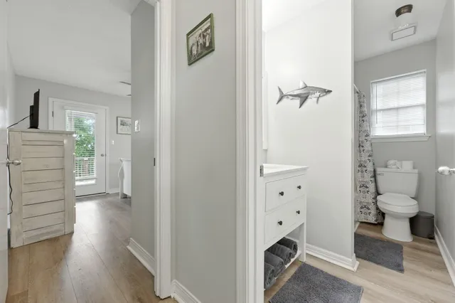 a white toilet sitting next to a bath tub