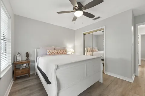 a bedroom with a bed and a chandelier