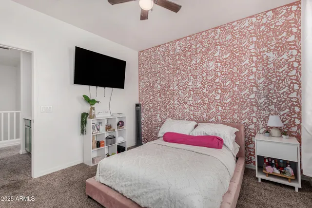 a bedroom with a bed and a flat screen tv