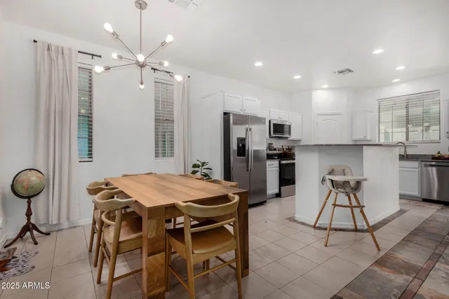 a kitchen with stainless steel appliances kitchen island granite countertop a refrigerator and a stove top oven