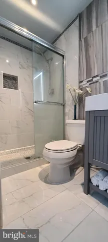 a white toilet sitting next to a bath tub