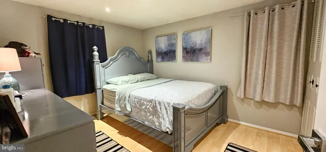 a bedroom with a bed and a mirror