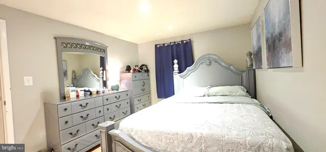 a bedroom with a bed and a dresser