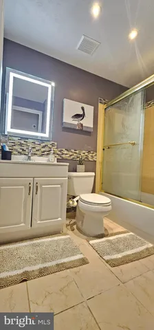 a spacious bathroom with a granite countertop sink and a mirror
