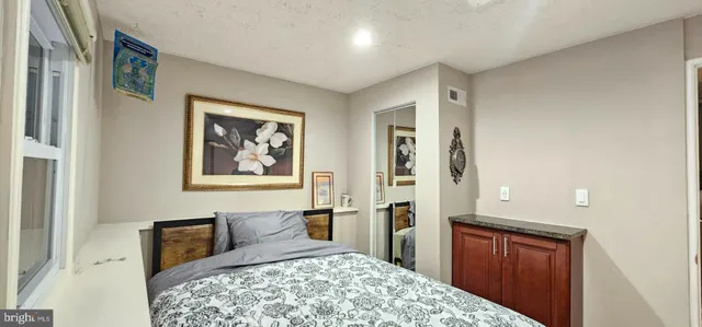 a bedroom with a bed and a dresser