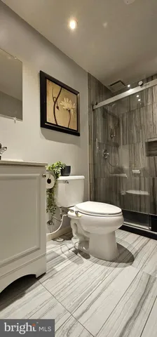 a bathroom with a toilet a sink and shower