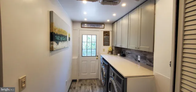 a kitchen with a sink a window and cabinets