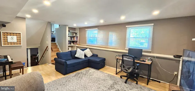 a living room with furniture rug and a window