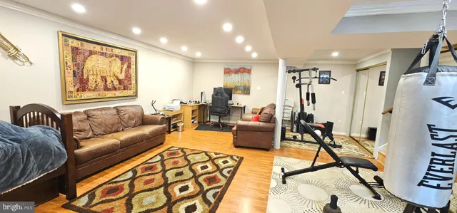 a living room with furniture kitchen view and a large window