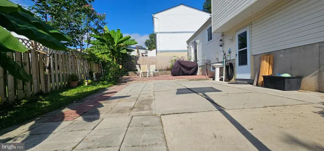 a backyard of a house with table and chairs
