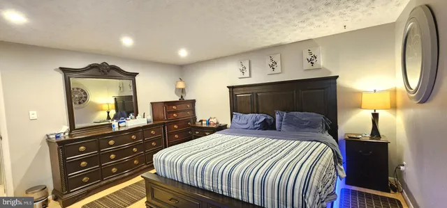 a bedroom with a bed and a mirror