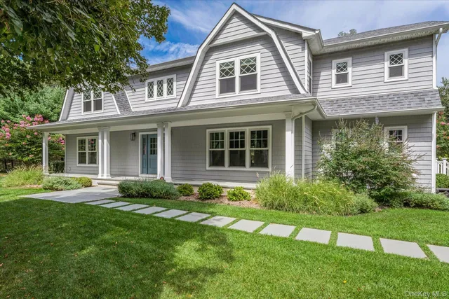 a front view of a house with a yard and porch