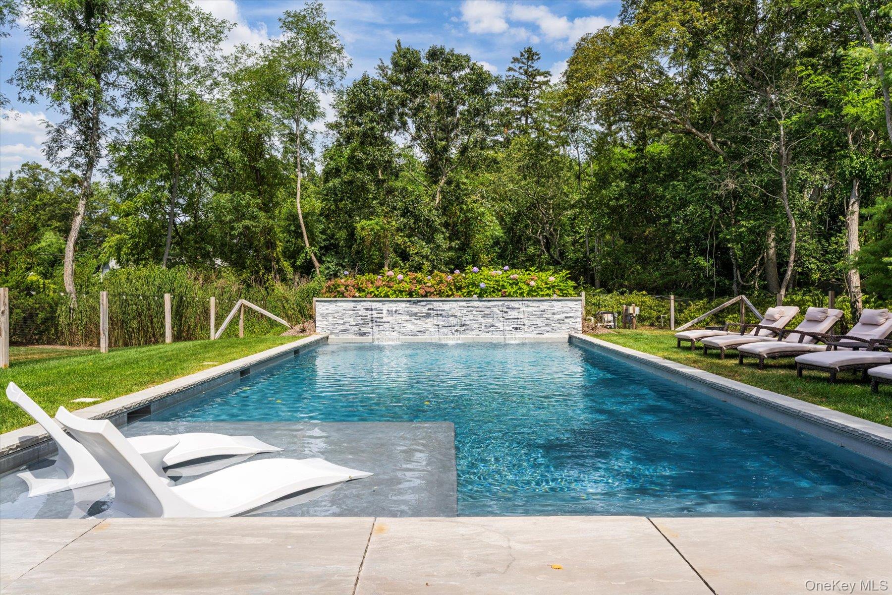 45 Old Sag Harbor Road Southampton, NY 11968 - Photo 11 of 47 a view of a backyard with swimming pool