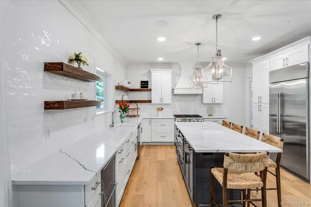 a view of entryway with furniture and wooden floor