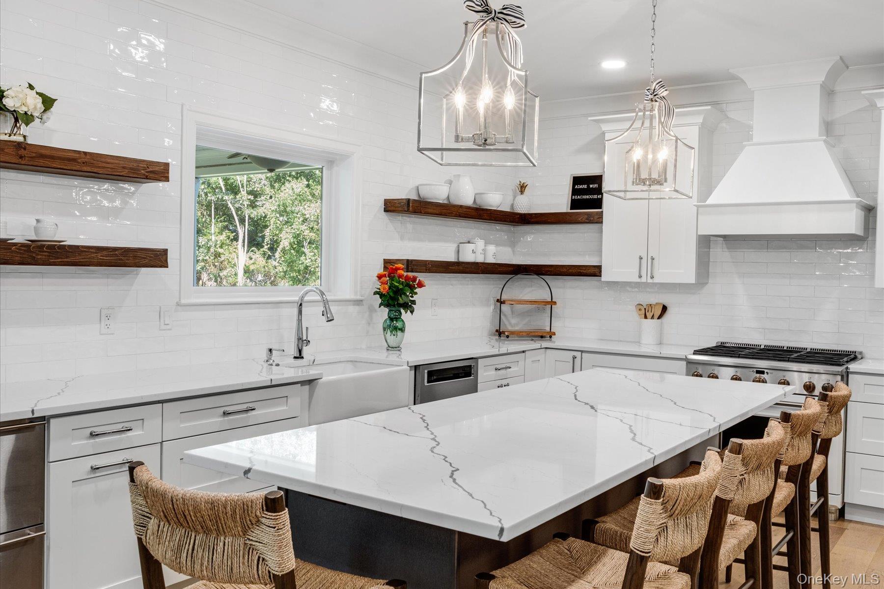 45 Old Sag Harbor Road Southampton, NY 11968 - Photo 19 of 47 a kitchen with stainless steel appliances a table chairs and a wooden floors