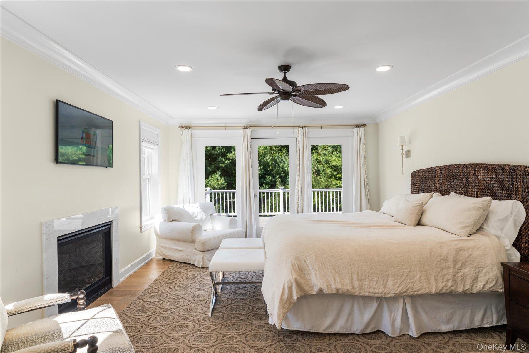 45 Old Sag Harbor Road Southampton, NY 11968 - Photo 31 of 47 a bedroom with a large bed and a fireplace