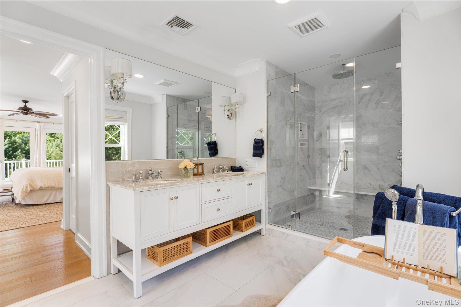45 Old Sag Harbor Road Southampton, NY 11968 - Photo 33 of 47 a bathroom with a double vanity sink a mirror and shower