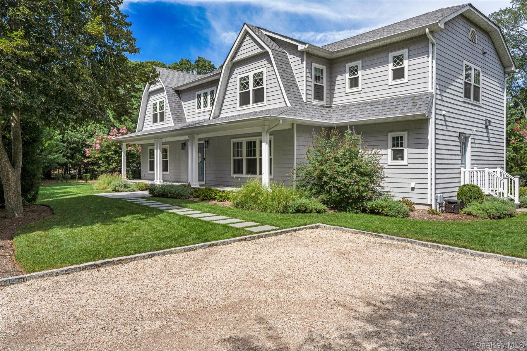 45 Old Sag Harbor Road Southampton, NY 11968 - Photo 4 of 47 a front view of a house with a yard and garage