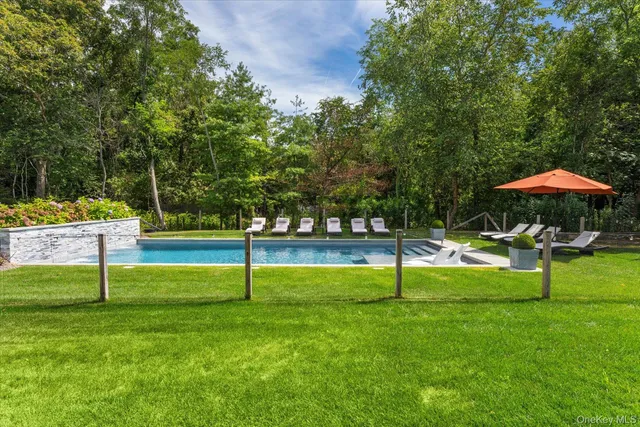 a view of house with backyard and outdoor seating