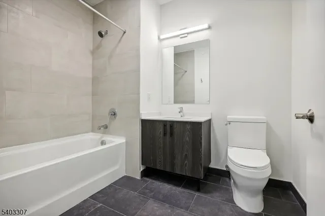 a bathroom with a toilet a sink and bathtub