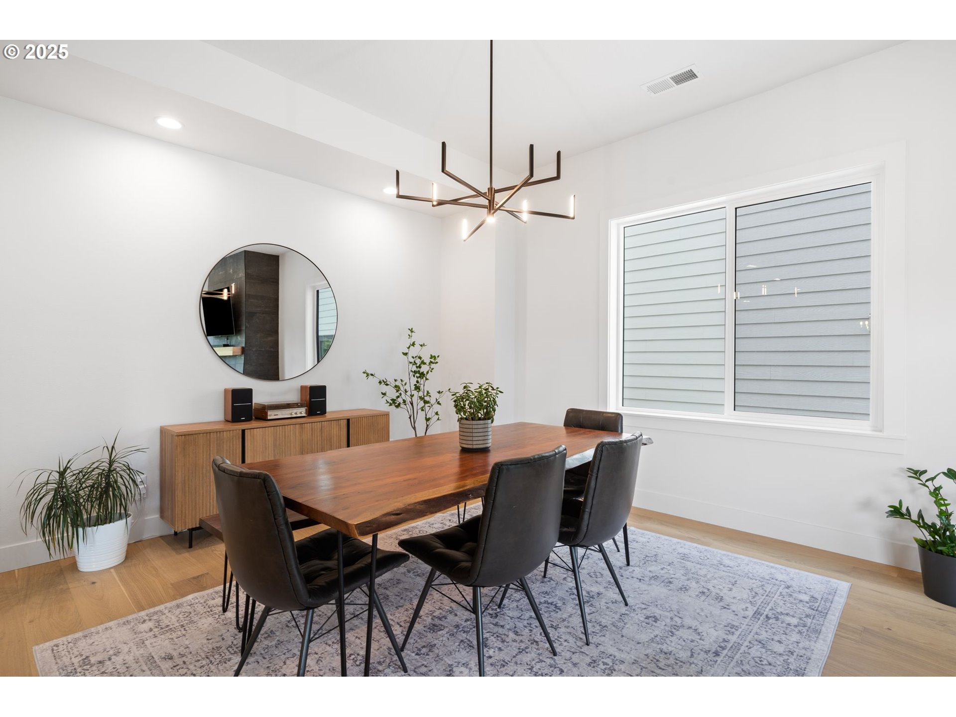 15625 Northwest Gooderham Street Portland, OR 97229 - Photo 11 of 45 a view of a dining room with furniture and a chandelier