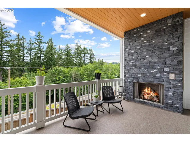 a living room with furniture a fireplace and a floor to ceiling window