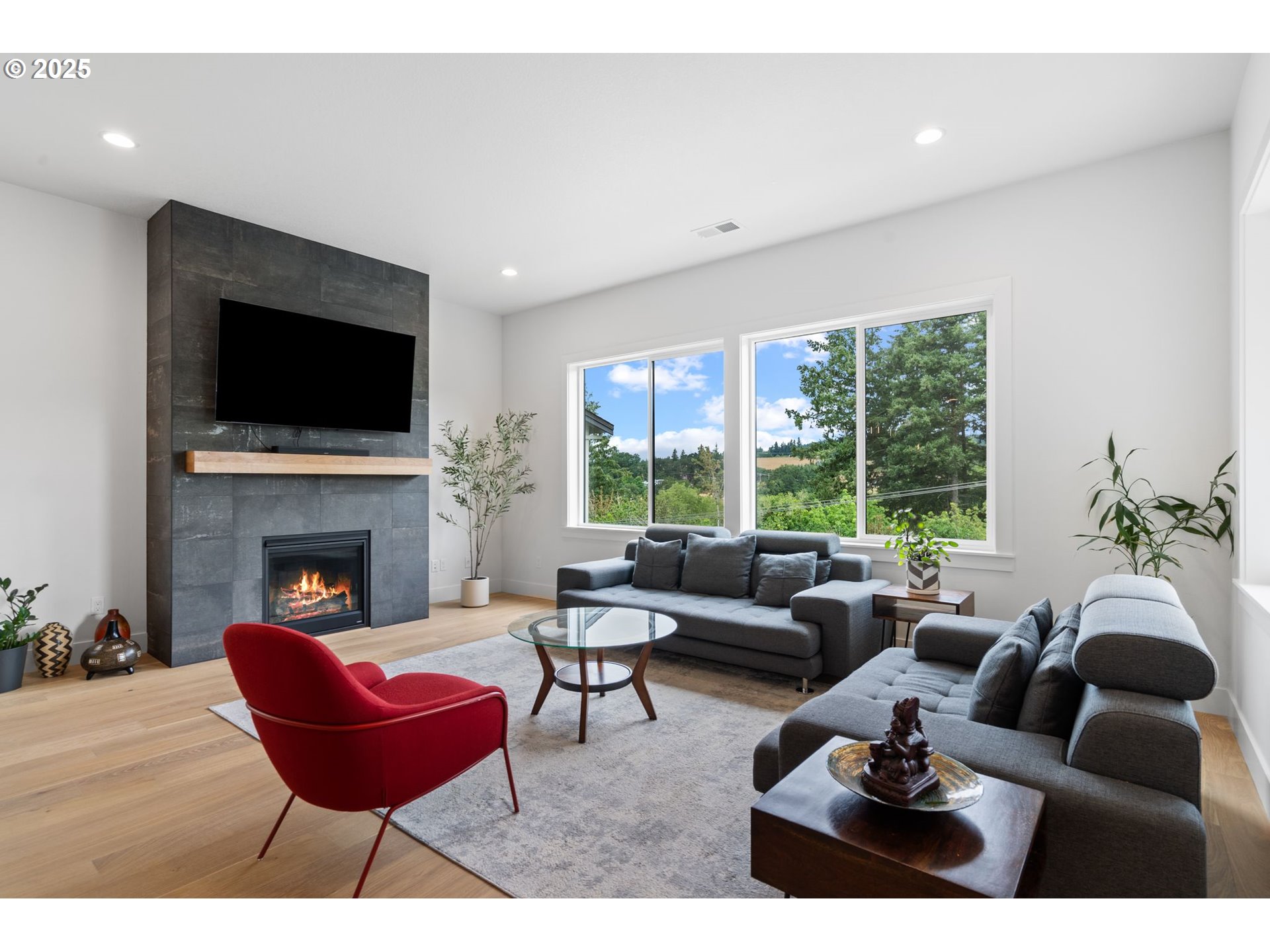 15625 Northwest Gooderham Street Portland, OR 97229 - Photo 7 of 45 a living room with furniture a fireplace and a flat screen tv