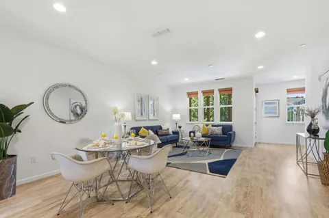 a living room with furniture a fireplace and wooden floor