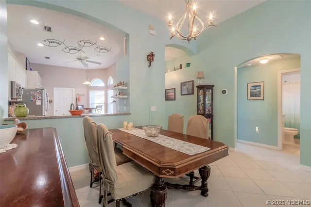 a view of a dining room with furniture and chandelier