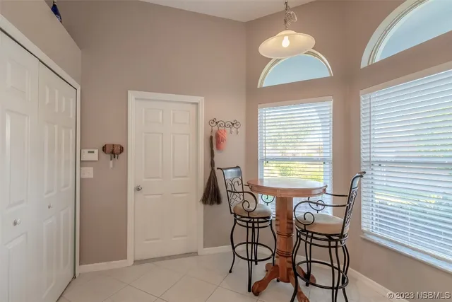 a view of a dining room with furniture and chandelier