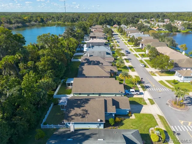 an aerial view of a house with a lake view