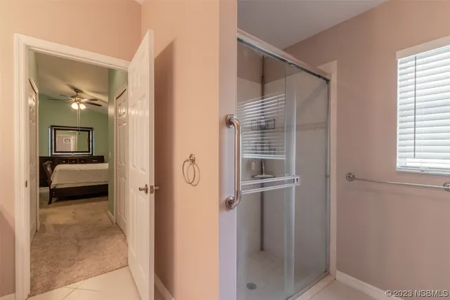 a view of a hallway with a livingroom and a bathroom
