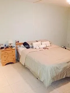 a bedroom with a bed and lamp