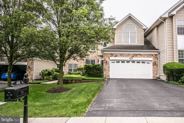 a view of a house with a yard and potted plants