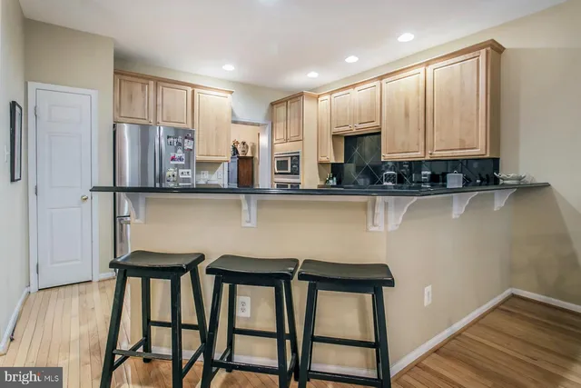 a kitchen with stainless steel appliances granite countertop a stove top oven a sink and cabinets