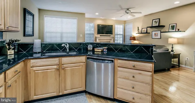 a kitchen with white cabinets and sink