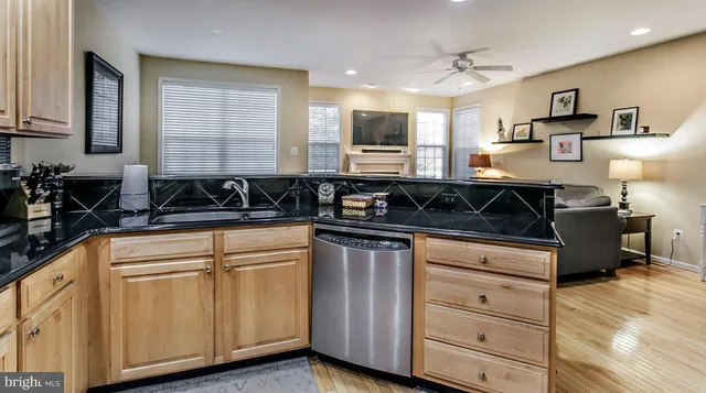 a kitchen with granite countertop a sink a stove and cabinets